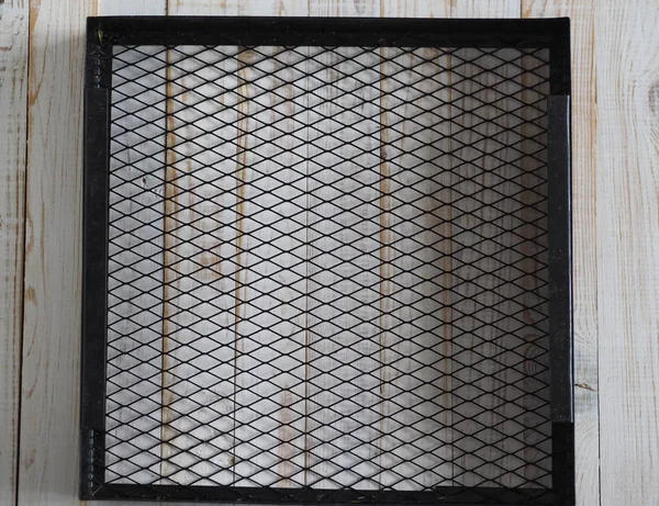 Black grid from a home dryer of fruits and vegetables.
