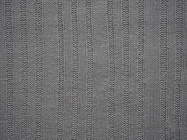 Knitted fabric texture. Gray. Simple knitting with front and back loops. Knitting on the knitting needles. Horizontal lines. — ストック写真