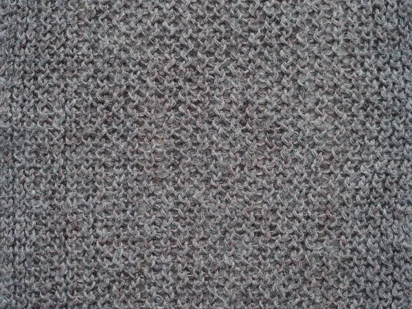 Knitted fabric texture. Gray. Simple knitting with front and back loops. Knitting on the knitting needles. Horizontal lines. — ストック写真