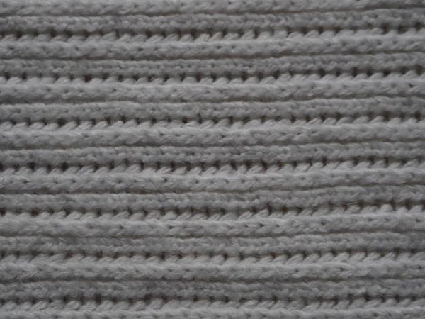 Knitted fabric texture. Gray. Simple knitting with front and back loops. Knitting on the knitting needles. Horizontal lines. — Stock Photo, Image