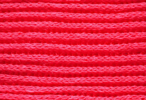 Knitted fabric texture. Red color. English knitting with front and back loops. Knitting on the knitting needles. Horizontal lines — Stock Photo, Image