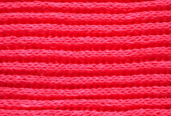 Knitted fabric texture. Red color. English knitting with front and back loops. Knitting on the knitting needles. Horizontal lines — Stock Photo, Image