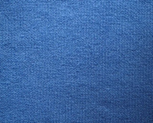 Knitted fabric texture. Blue. Garter stitch with facial loops. Knitting on the knitting needles. Knitted background. — Stock Photo, Image