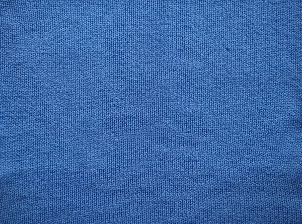 Knitted fabric texture. Blue. Garter stitch with facial loops. Knitting on the knitting needles. Knitted background. — Stock Photo, Image