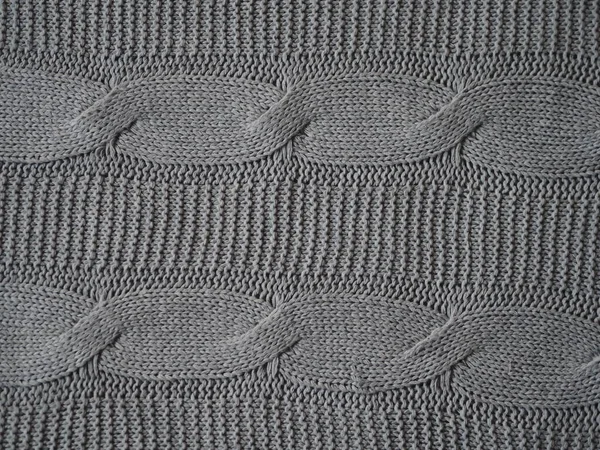 Knitted fabric texture. Gray. Simple knitting with front and back loops. Knitting on the knitting needles. Horizontal lines. — ストック写真