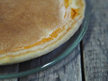 Yuvarlak ev yapımı balkabaklı turta, doğranmış ceviz, çırpılmış yumurtaya şeker. Ahşap kırsal arka plan. Ev yapımı pişirme..