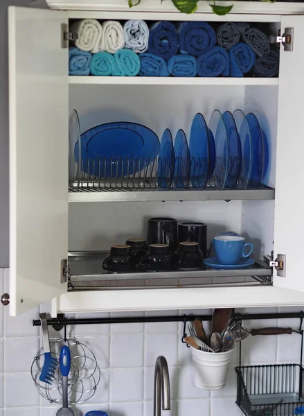 A cabinet for storing cookware and kitchen linen. Dryer. Rustic cuisine.