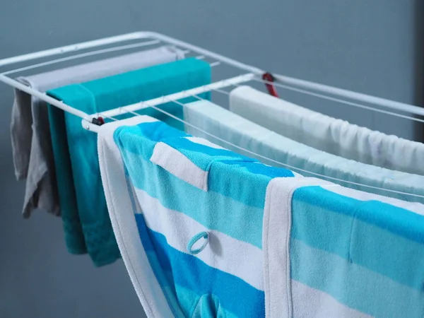 Dry clothes on the dryer in the house after washing. Cleanliness, hygiene. — Stock Photo, Image