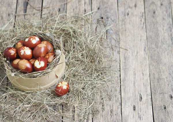 Christ is risen. Onion-painted eggs on dried grass in a nest. Traditional spring festive orthodox food. Easter Sunday. Royalty Free Stock Photos