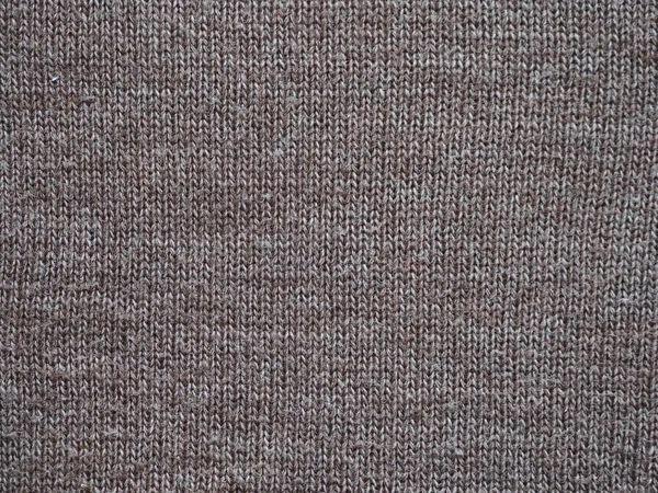 Fragment of a knitted fabric of handkerchief hand-knitted brown wool. View from above. — 스톡 사진