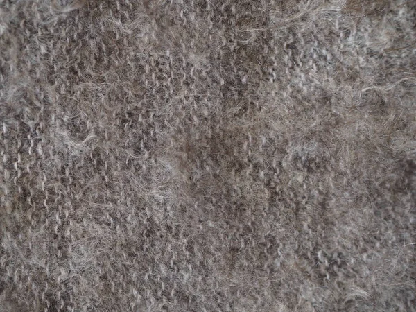 Fragment of a knitted fabric of a fluffy shawl handmade from natural goat hair of brown color. View from above. Horizontal. — 스톡 사진