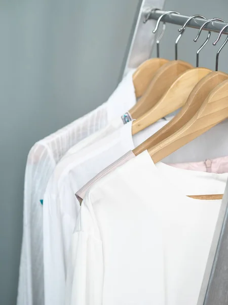 Storage of white and light items on the shoulders of hangers.