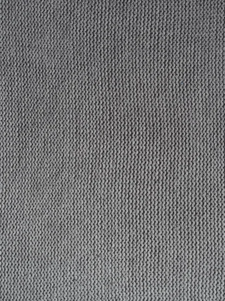 Gray knitted textured background, knit with purl loops. Hand knitting.