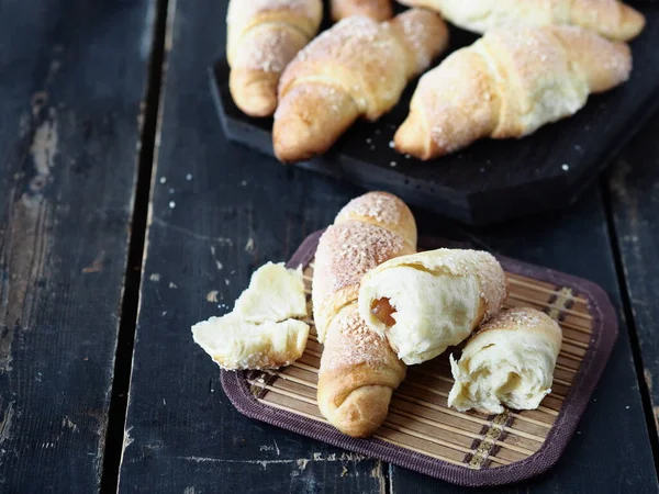 Croissants Espolvoreado Con Sésamo Azúcar Sobre Fondo Madera Oscura Pastel —  Fotos de Stock