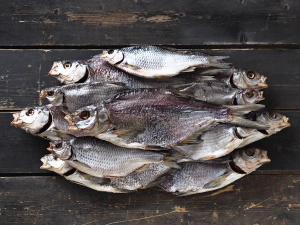 Air-dried,privately owned, freshwater river fish bream, on a dark wooden table. Close up.