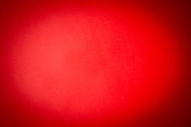 Kenarlarında vignette olan kırmızı kağıt arka plan. Kırmızının koyu bir gölgesinde parlak kırmızı bir arka plan. Ortası aydınlık ve kenarları kararmış..