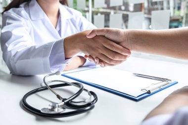 Doctor and patient shaking hands after checking with consultatio