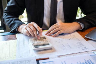 business investor or accountant working and using calculator, wr