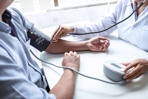 Doctor using stethoscope checking measuring arterial blood press