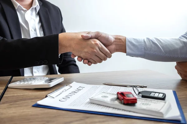 Car rental and Insurance concept, Young salesman shaking hands a