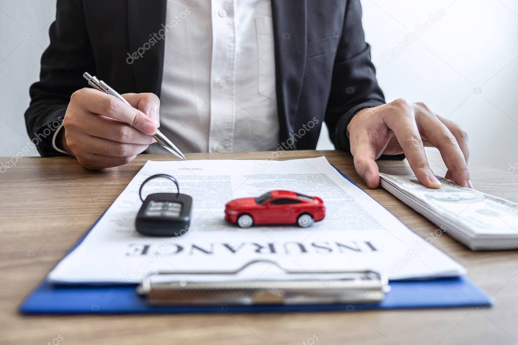 Car rental and Insurance concept, Young salesman receiving money