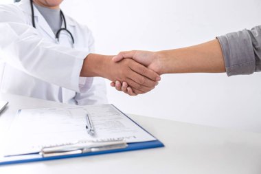 Finishing of consulting, Doctor and patient shaking hands after 