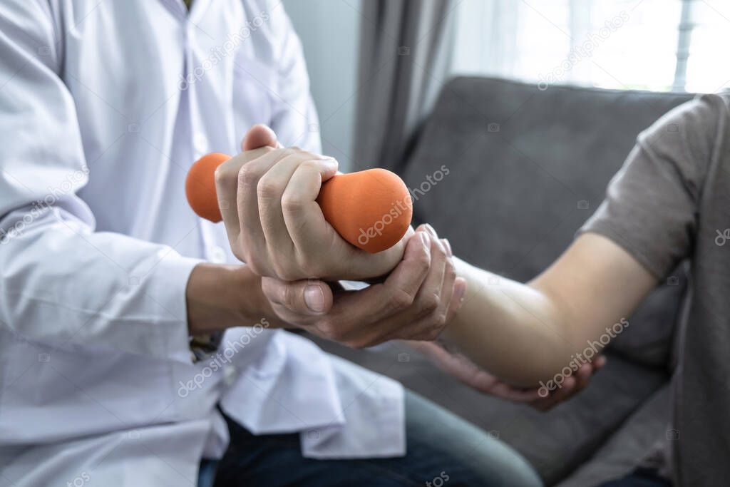 Doctor physiotherapist treating rehabilitation arm pain patient 