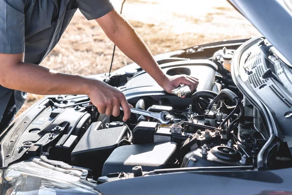 Technician hands of car mechanic in doing auto repair service an — 스톡 사진