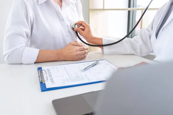 Médico usando un estetoscopio que revisa al paciente sobre el problema de — Foto de Stock