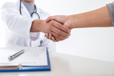 Finishing of consulting, Doctor and patient shaking hands after 