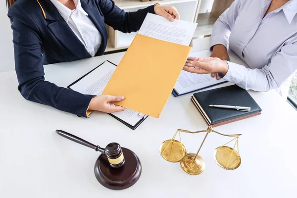 Professional female lawyer or counselor discussing negotiation legal case with client meeting with document contract in office, law and justice, attorney, lawsuit concept.