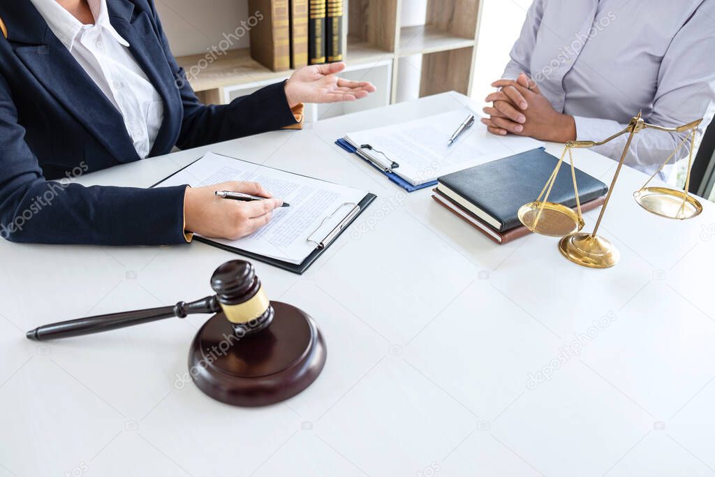 Professional female lawyer or counselor discussing negotiation legal case with client meeting with document contract in office, law and justice, attorney, lawsuit concept.