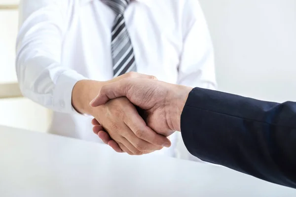 Good deal of interview, Business people and recruiter shaking hands greeting or get acquainted of conducting a job interview while sitting at the working meeting in office.