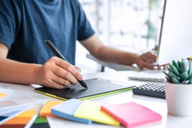 Genç İç mimar grafik tasarım projesi, grafik tablet üzerinde çalışıyor modern ofiste çalışıyor, yaratıcı ilham ve hayal.