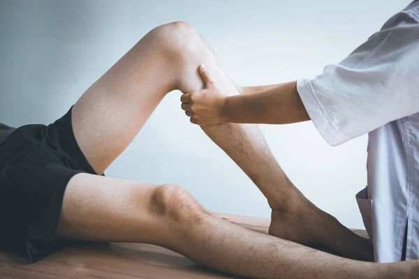 Doctor Physiotherapist Working Examining Treating Injured Leg Athlete Male Patient — Stock Photo, Image