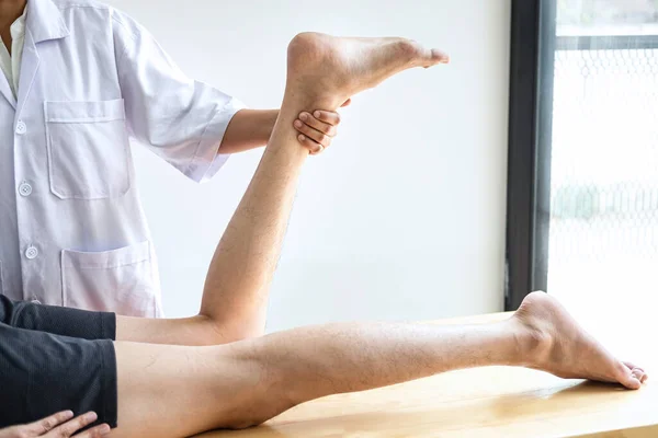 Doctor Physiotherapist Working Examining Treating Injured Leg Athlete Male Patient — Stock Photo, Image