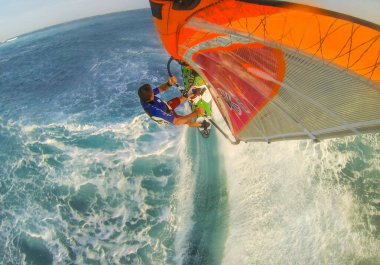 Photo of jumping windsurfer captured from the top of the mast clipart