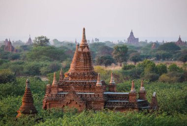Bagan Vadisi, Myanmar 'daki antik pagoda mahzenlerinin üzerinde güzel bir günbatımı.