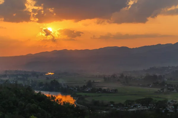 Myanmar 'daki pirinç tarlalarının, dağların ve bulutların üzerinde güzel bir günbatımı