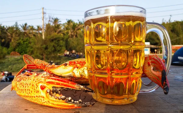 Crab with a huge claw and a mug of light beer — 스톡 사진