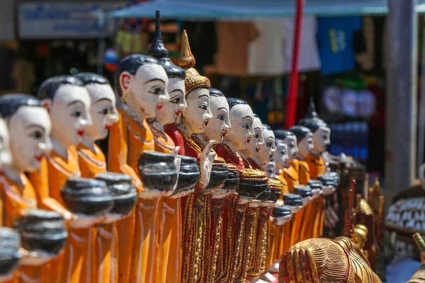 Figurines of monks collecting donations in the ancient souvenir market in Myanmar