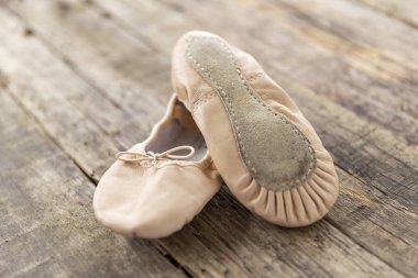 ballet shoes laying on rough vintage wood, with natural light, Ballet shoes for Kids
