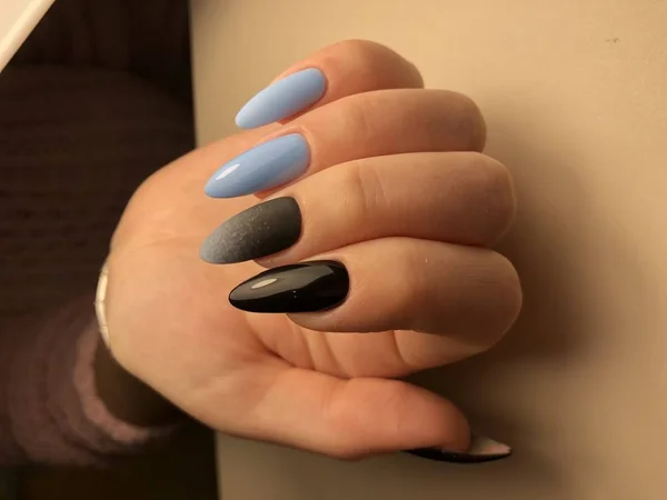 Idea for manicure and waxed nails. Nails made up.  bright color on the hands, nails with manicure, blue color on the hands.  female fingers, nail care, beautiful hands.