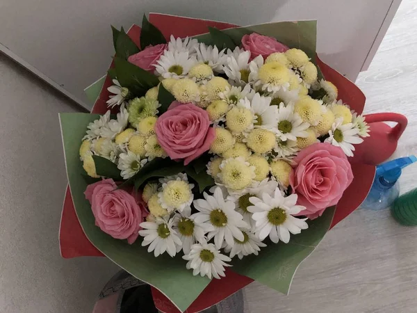 Multi-colored bouquet of flowers in a beautiful package.Multi-colored bouquet of flowers in a beautiful package.A bouquet of flowers from loved ones and a loved one, joy and happiness in the eyes, being loved to feel love, joy and happiness, rest