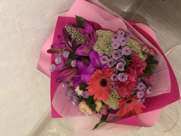 A bouquet of flowers from loved ones and a loved one, joy and happiness in the eyes, being loved to feel love, joy and happiness, rest from worries, a beautiful wrapper and. A homemade bouquet of flowers on a typical weekday is a simple joy of dreams