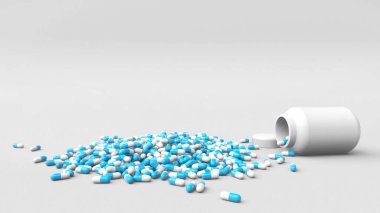 Yerdeki beyaz-mavi renkli ve 3D işlemeli bir çok ilaç kapsülü.