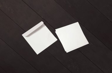 White envelope and post card on red background. Top view blank envelope mockup and blank letterhead presentation template. Empty sheet for your design.