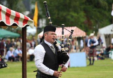 CRIEFF, SCOTLAND, 21 JULY 2018: Unknown competitors during the piping competition at the Lochearnhead highland Games near Crieff in Scotland. An annual event promoting Highland culture and traditions.