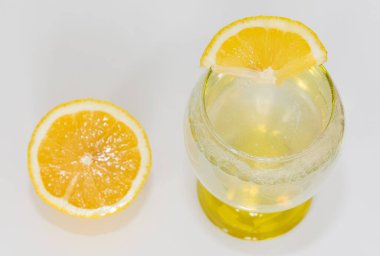 Beyaz arka planda dilimlenmiş limon ve limon aromalı maden suyu fotoğrafları.
