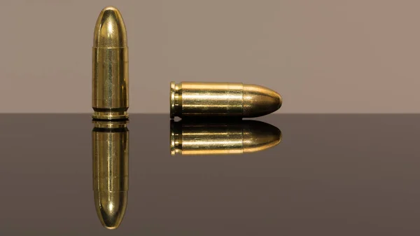 close-up photos of handguns and pistol bullets